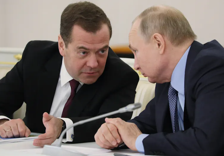 Dmitry Medvedev speaking with Vladimir Putin in 2019.