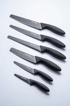 Six round-tip kitchen knives of varying sizes, lined up on a plain white background