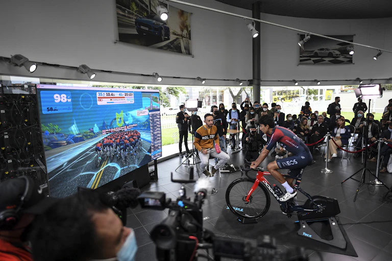 Cyclisme professionnel testant le cyclisme virtuel devant des caméras.