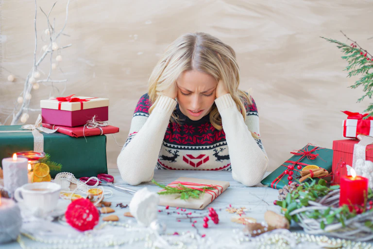 A stress out woman takes a break while wrapping presents.