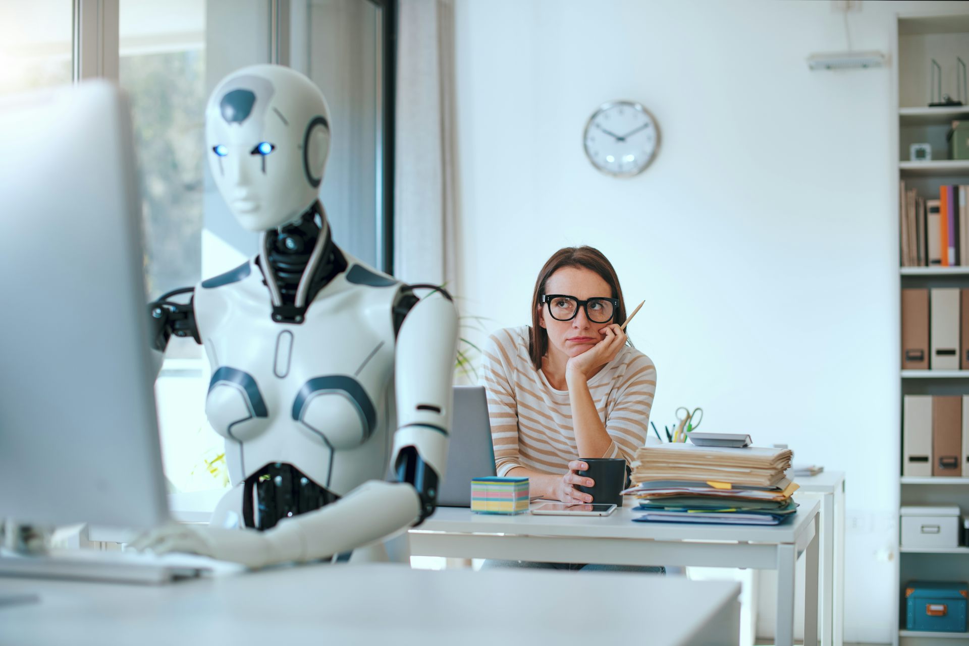 office worker staring at a robot colleague