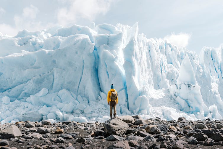 Person looks at glacier