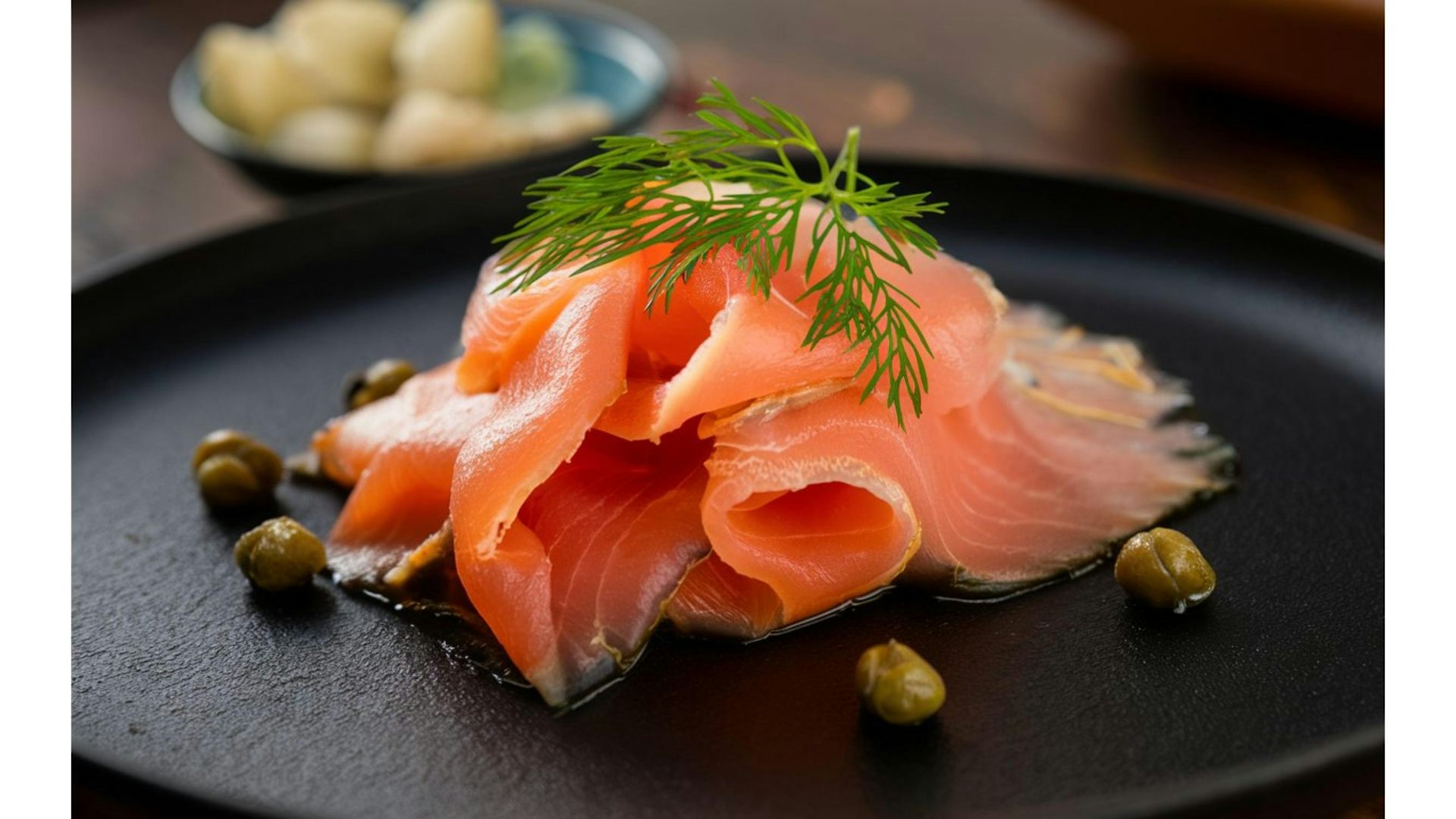 a slice of smoked salmon on a black plate