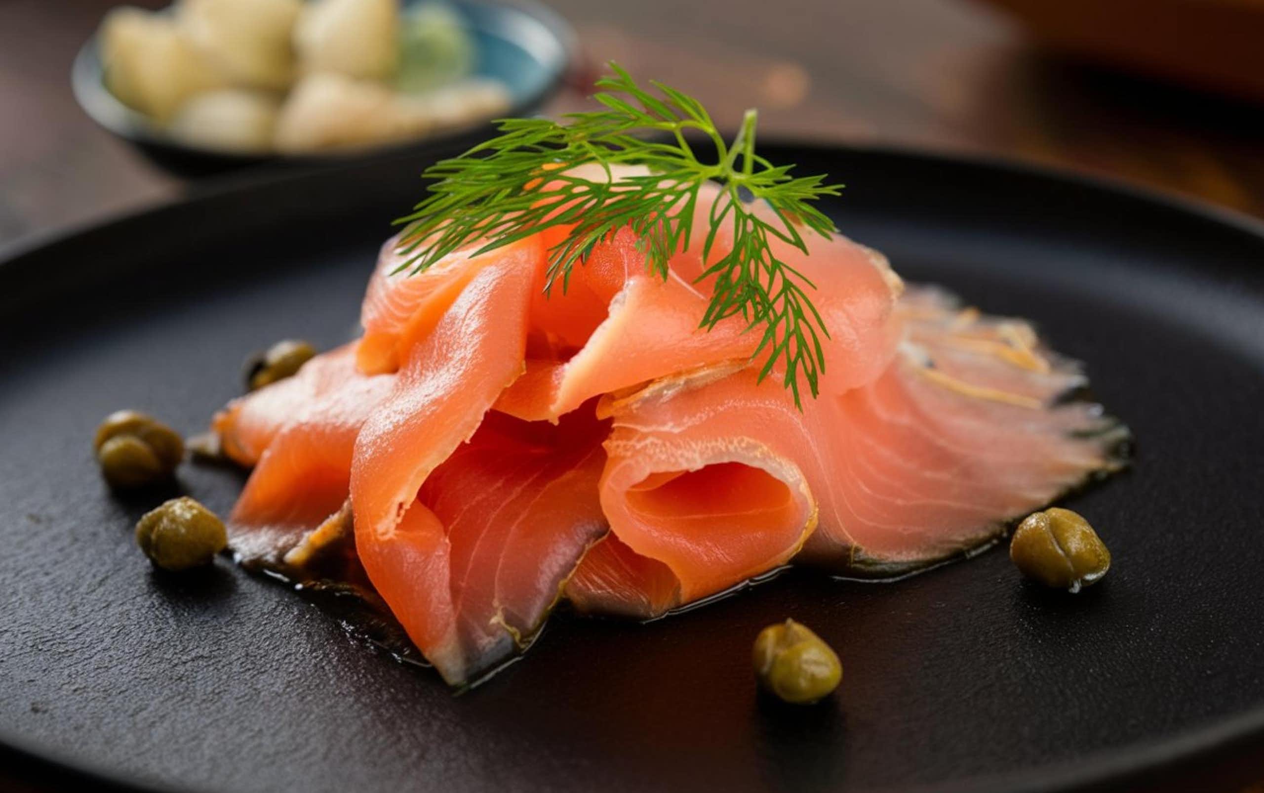 a slice of smoked salmon on a black plate