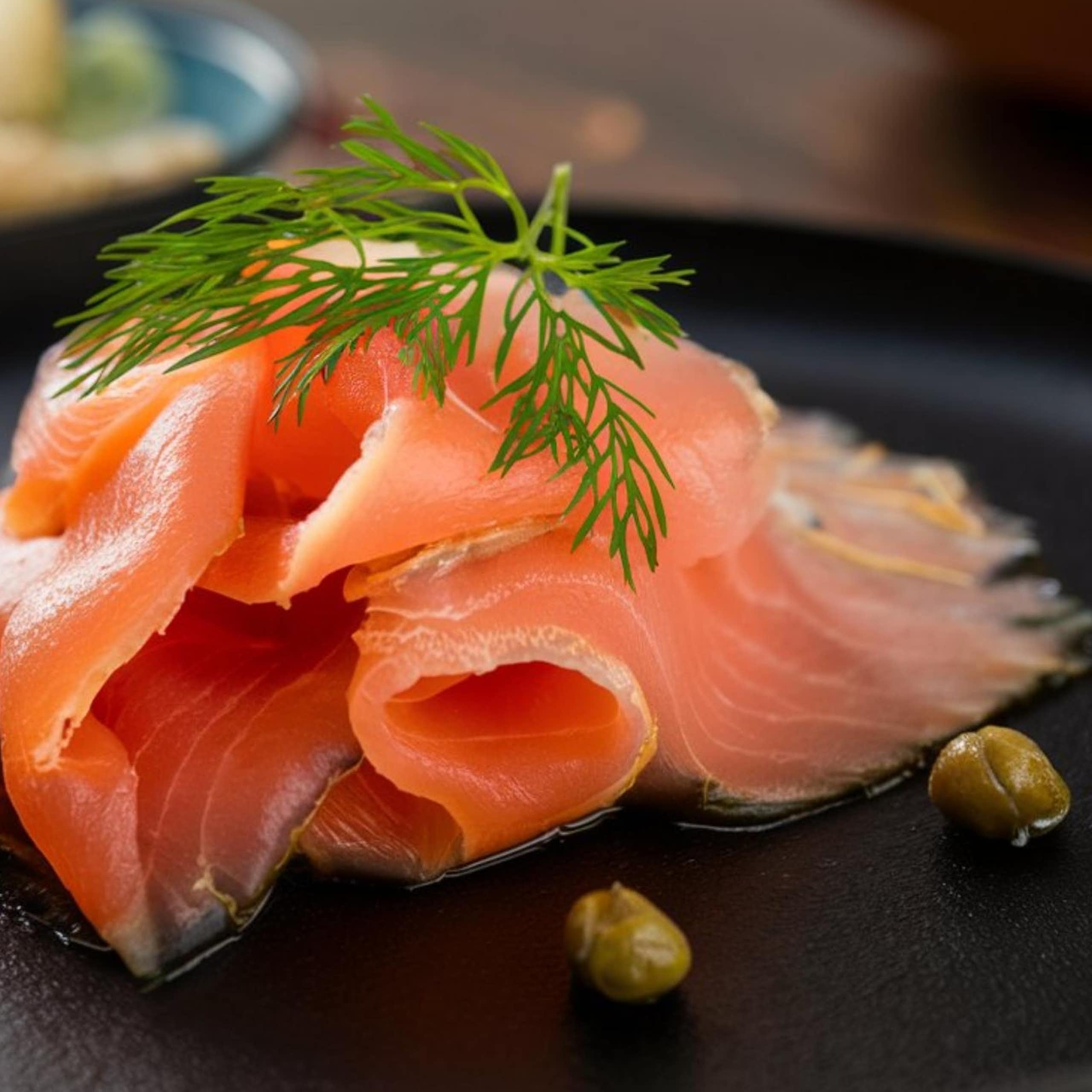 a slice of smoked salmon on a black plate