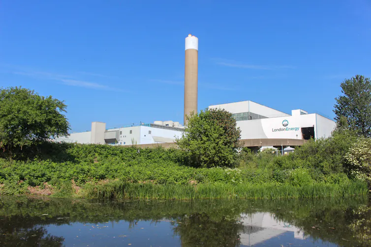 A power plant on the bank of a river.
