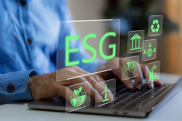 Pair of hands typing on a computer keyboard with green text that says ESG floats above
