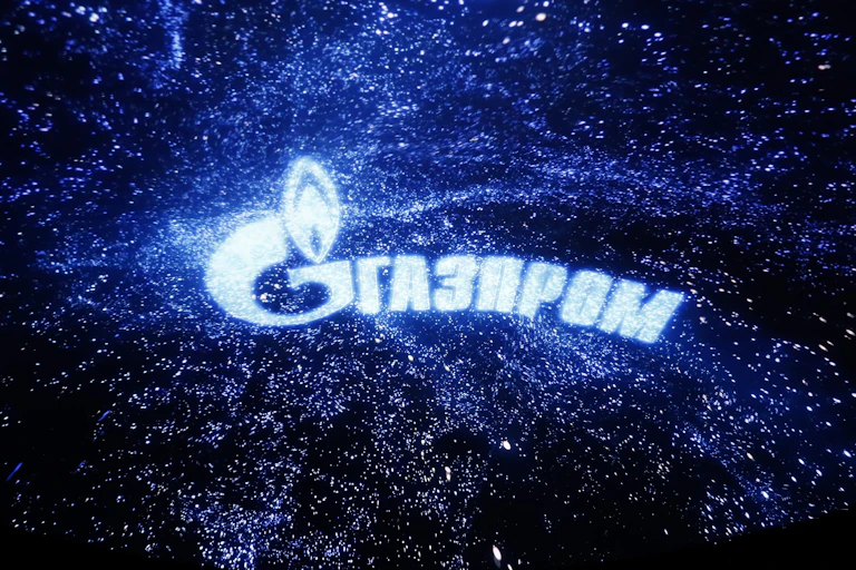 Gazprom logo against a starry sky background.