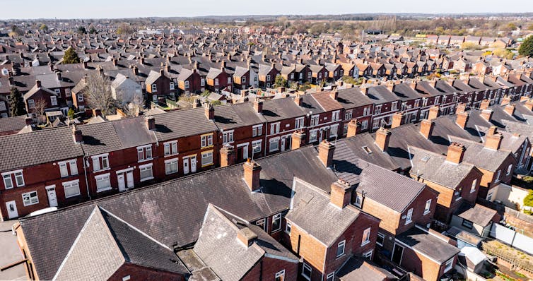 An aerial view above the rooftops of run down back to back terraced houses
