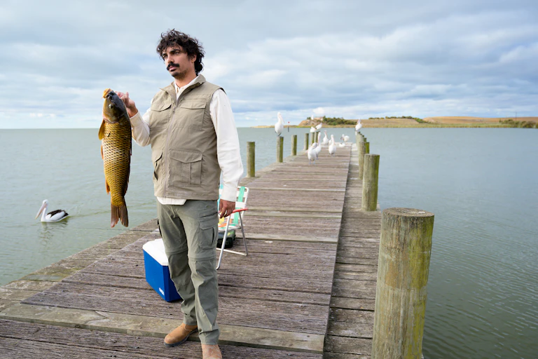 Tony Armstrong holds up a carp.