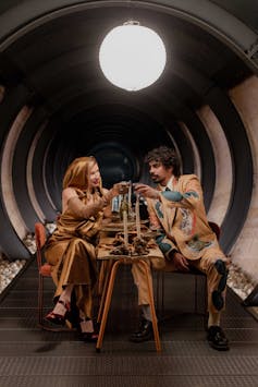 Kirsha Kaechele and Tony Armstrong at a dining table.