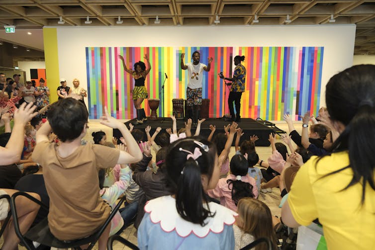 Children watch a band play.