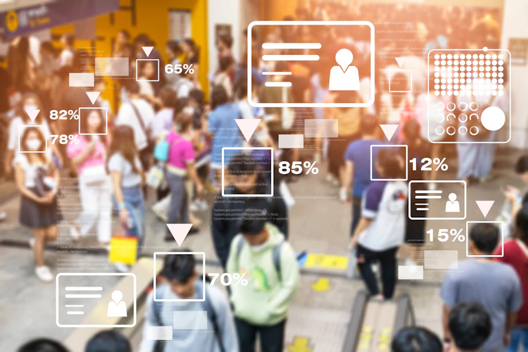 graphic concept showing facial recognition technology and data overlaid on photo of people walking