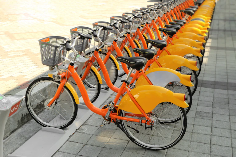 A row of electric orange bikes.