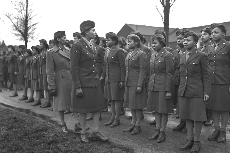 Black women in army uniform, lined up for inspection