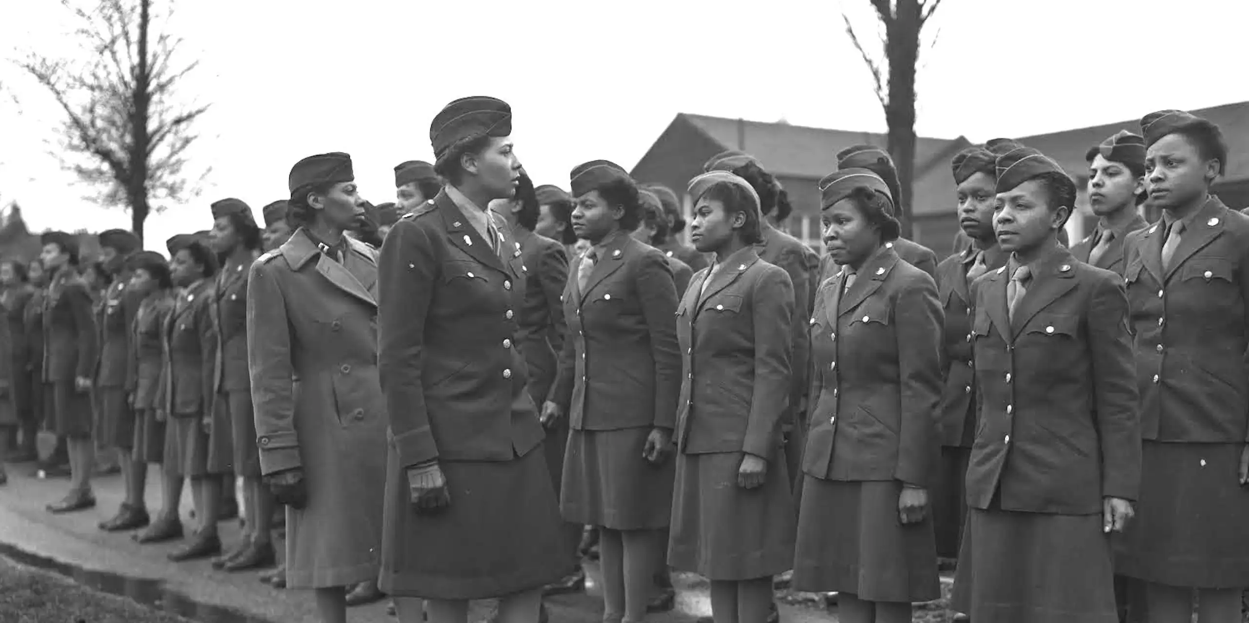 Black women in army uniform, lined up for inspection