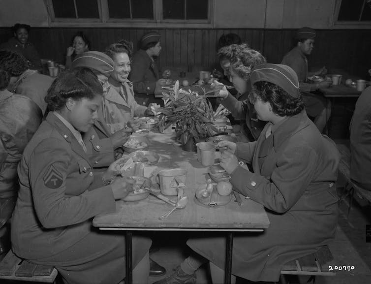 Women sat at a table eating lunch