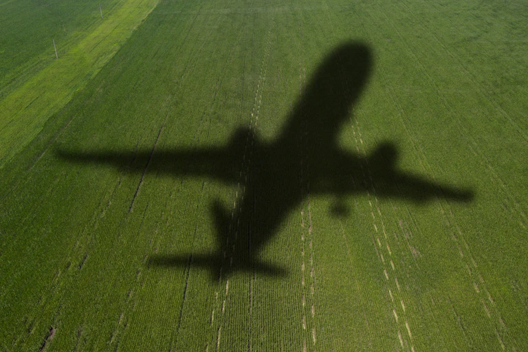 shadow of airplane on green field