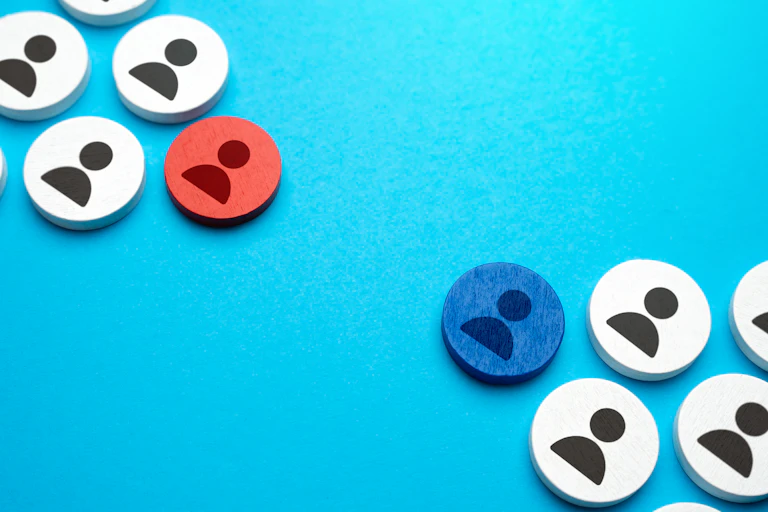 two groups of round buttons with silhouettes of a person are on a light blue background, one of the buttons is red and one is blue
