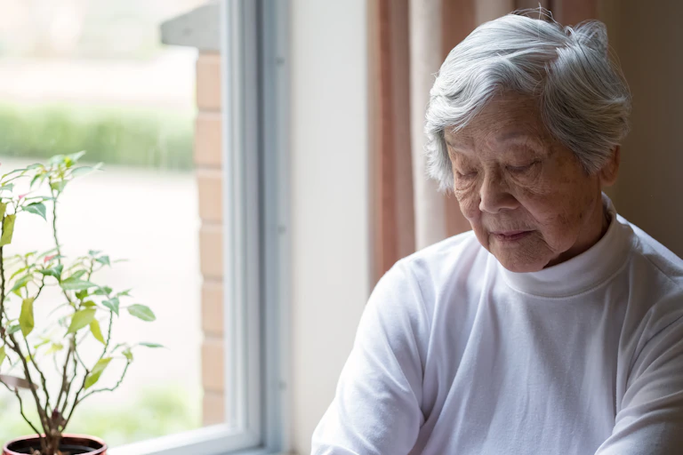 Older Chinese woman at a window.