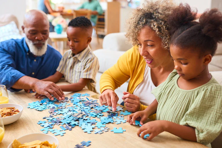 Grandparents doing a jigsaw with children