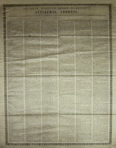 A large ivory piece of silk with black printing on it.