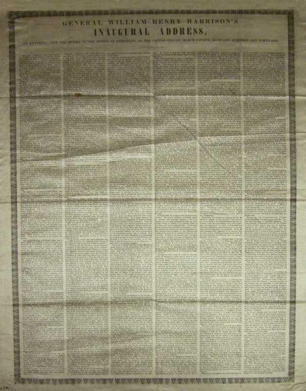 A large ivory piece of silk with black printing on it.