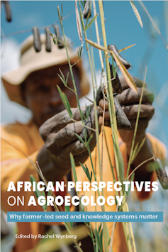 A photo of the book cover depicting a man in a straw hat working with seeds on a crop