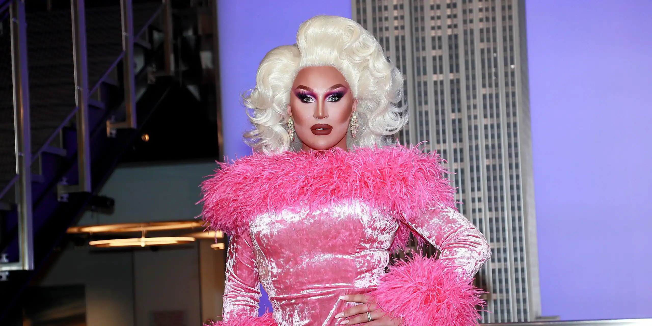 The Vivienne in a blonde wig and pink fluffy dress