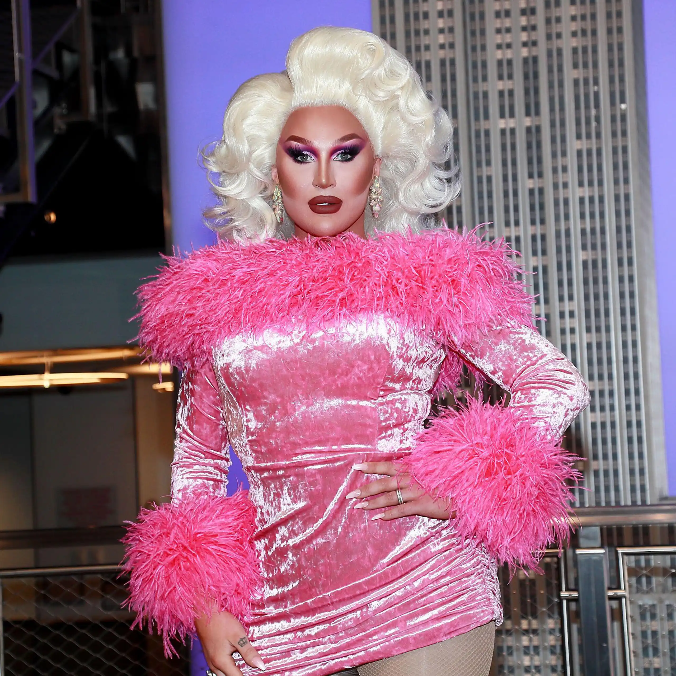 The Vivienne in a blonde wig and pink fluffy dress