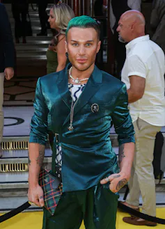 Williams on a 'yellow carpet' with green slicked back hair and a green velvet blazer