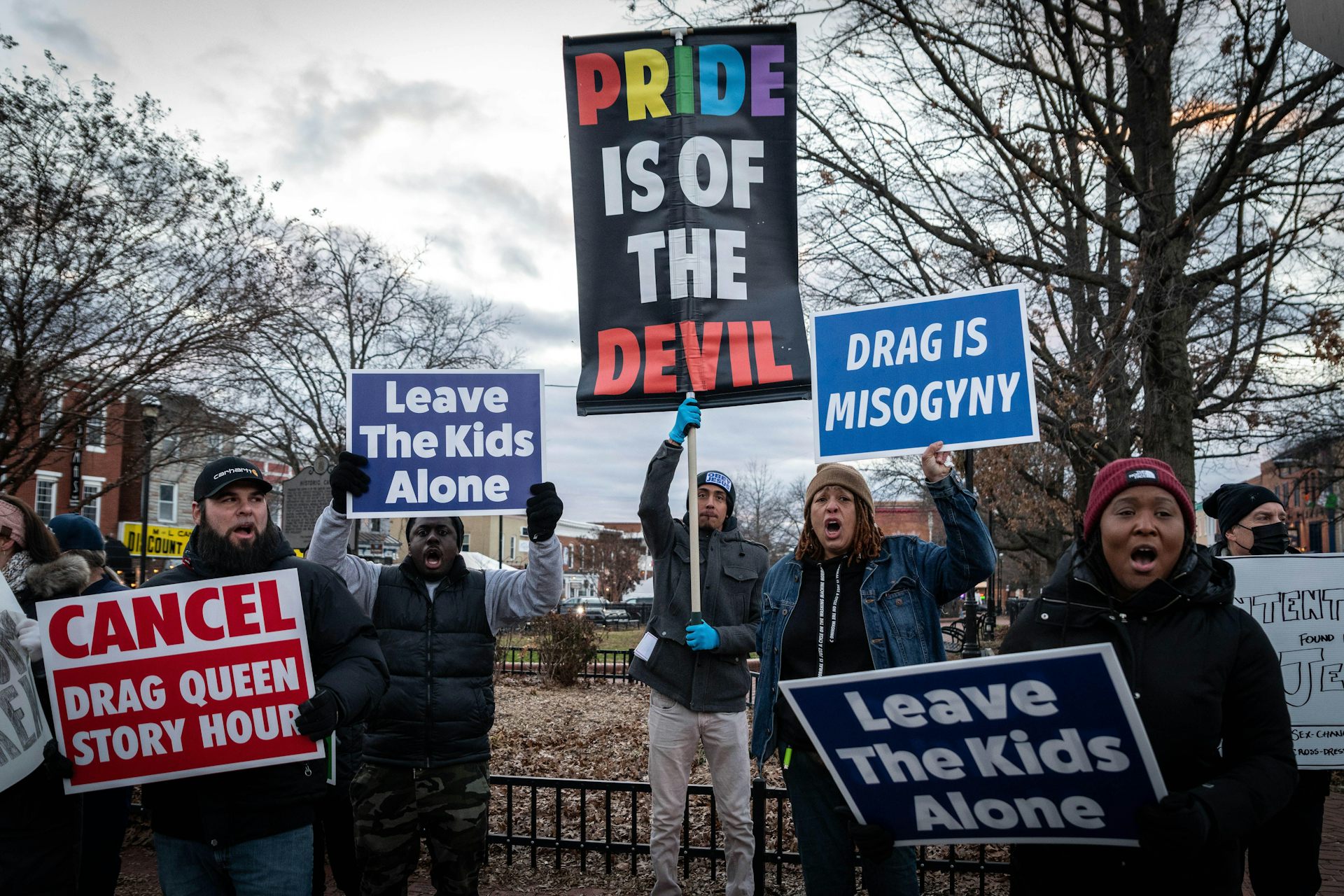 Protestors holding anti-drag signs