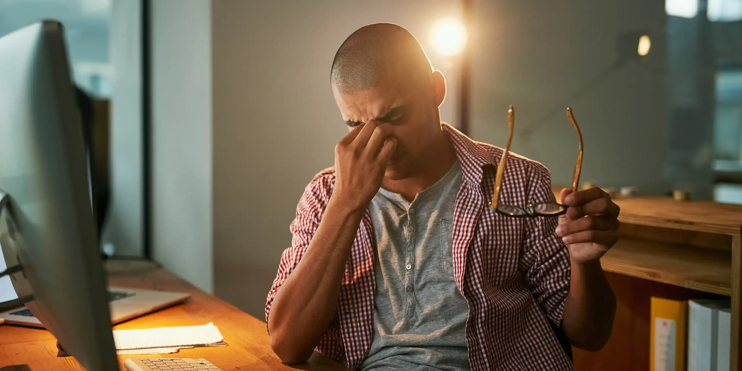 stressed man sitting at a computer