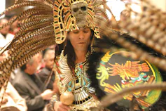 A member of the Danza Azteca dances in feathered garb.