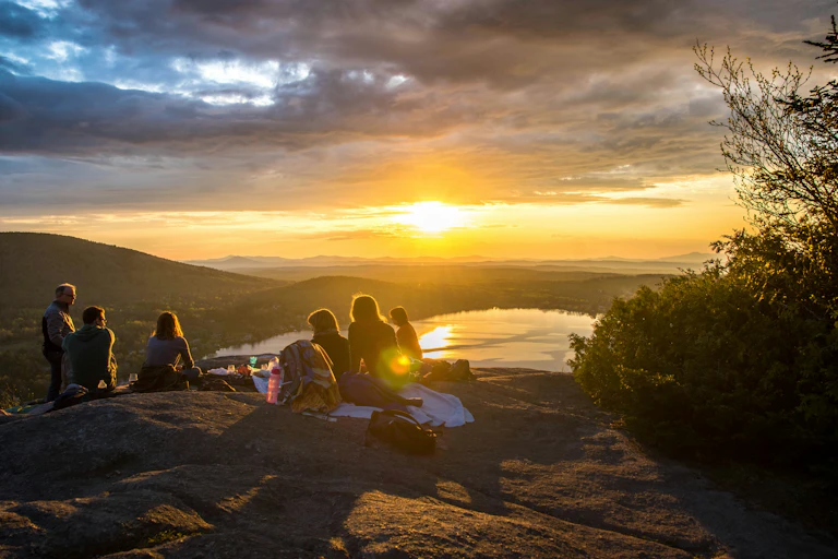 Group of people outdoors in nature as sun sets