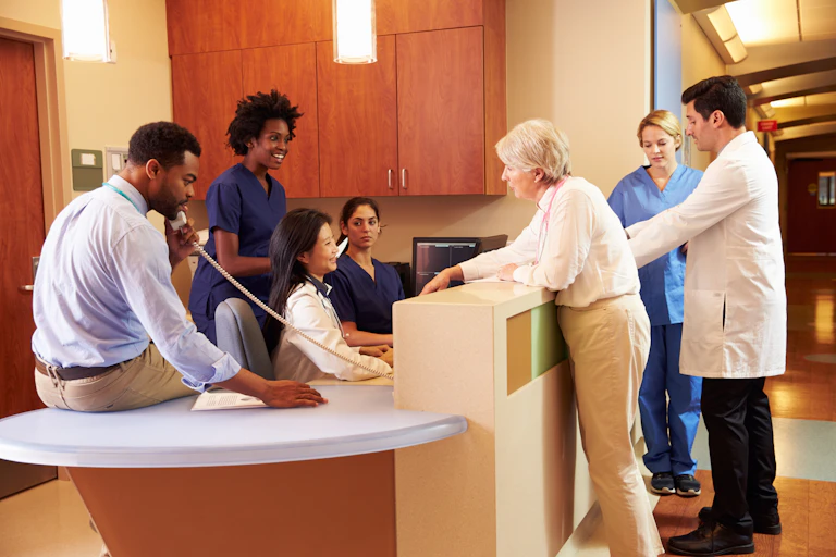 Health-care colleagues gathered at a clinic reception desk