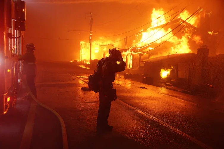 A firefighter stands in a street in LA