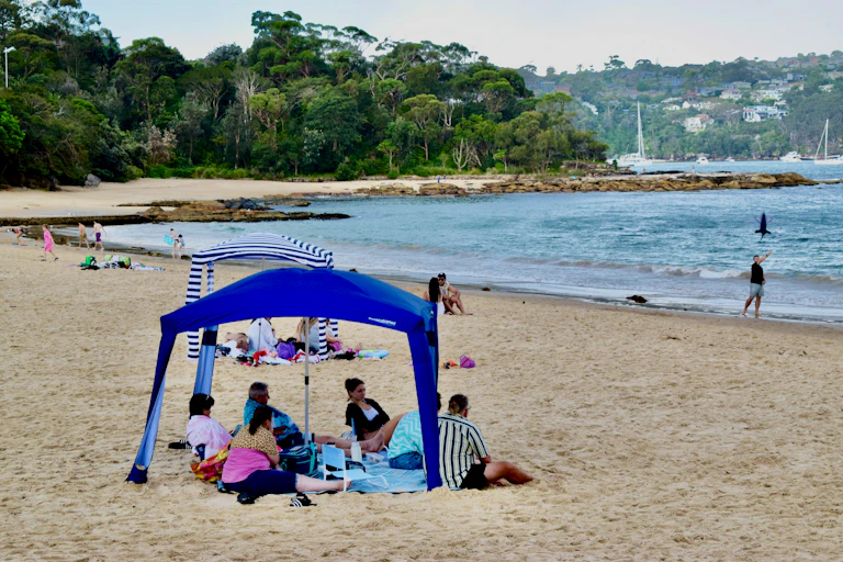 group of people on beach under cabana