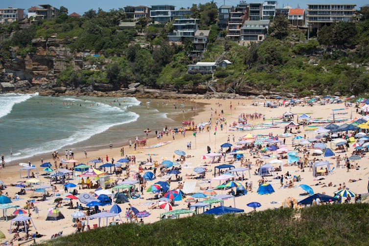 umbrellas and cabanas on crowded beach