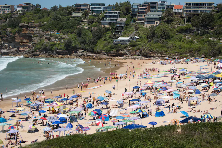 umbrellas and cabanas on crowded beach
