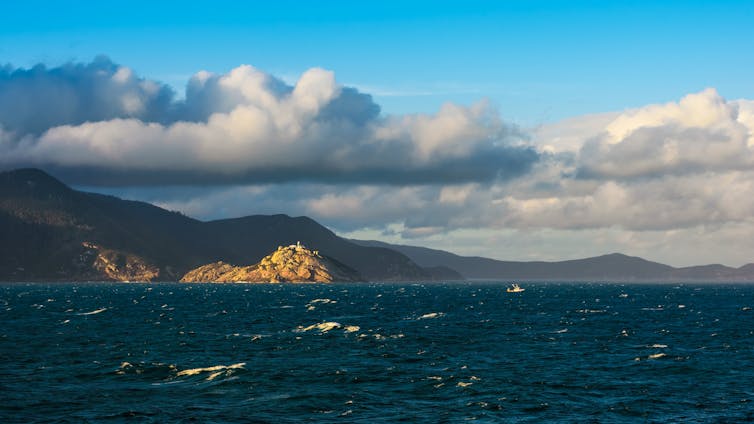 choppy seas, island and cloud