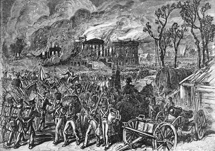 A wood engraving of British soldiers stationed in front of the White House, which is on fire