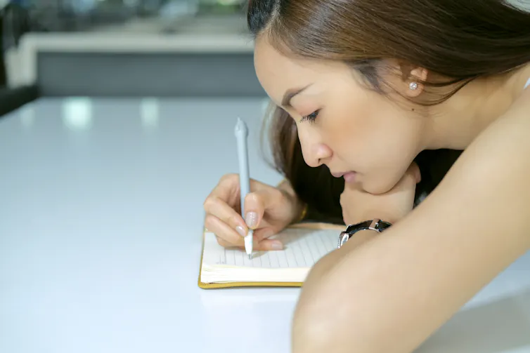 Girl writing in notebook