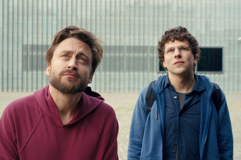 Kieran Culkin and Jesse Eisenberg looking to the sky