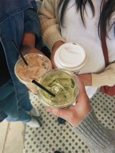 Three friends holding coffees