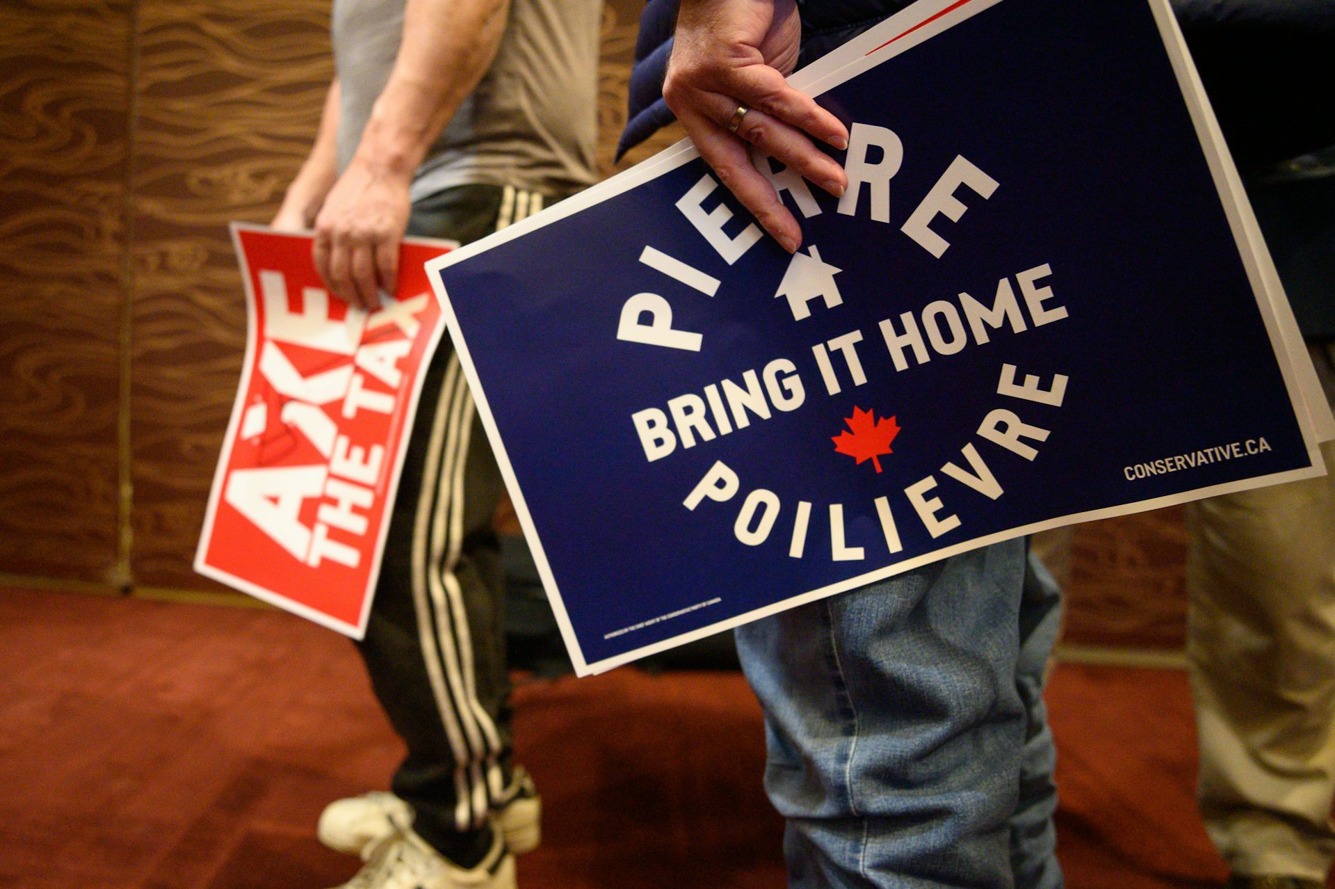 A group of people hold signs.