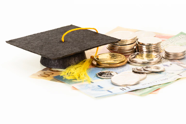 A graduation cap and money.