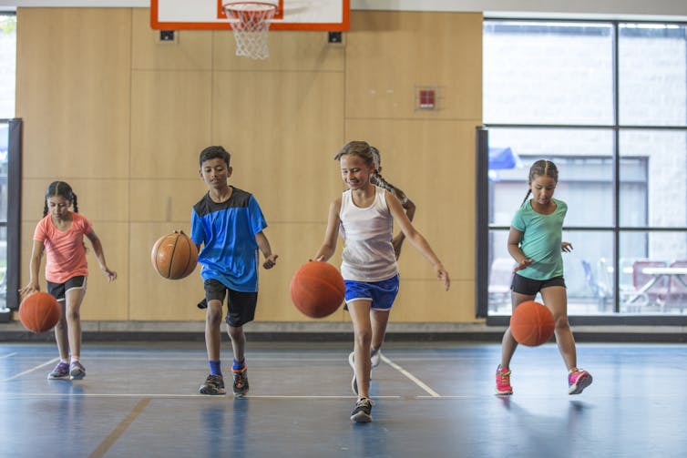 Children playing with basketballs