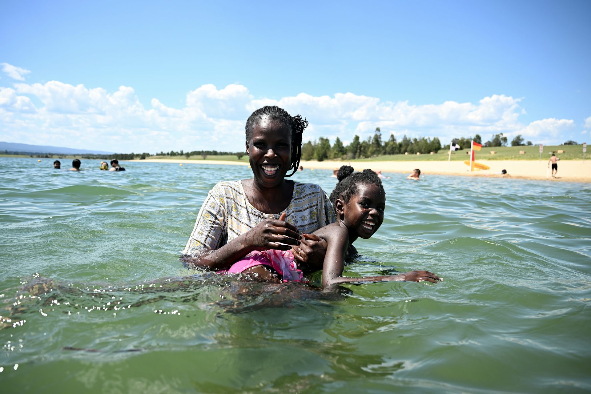 a woman and her daughter smiling in the water