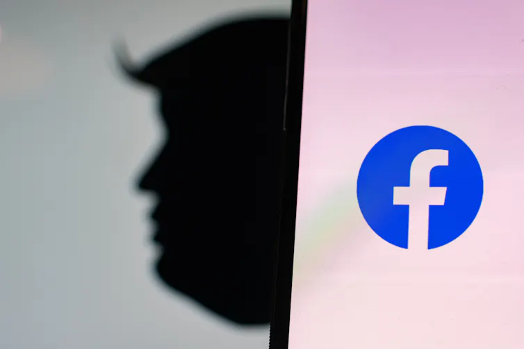 Donald Trump silhouette and Facebook logo on phone